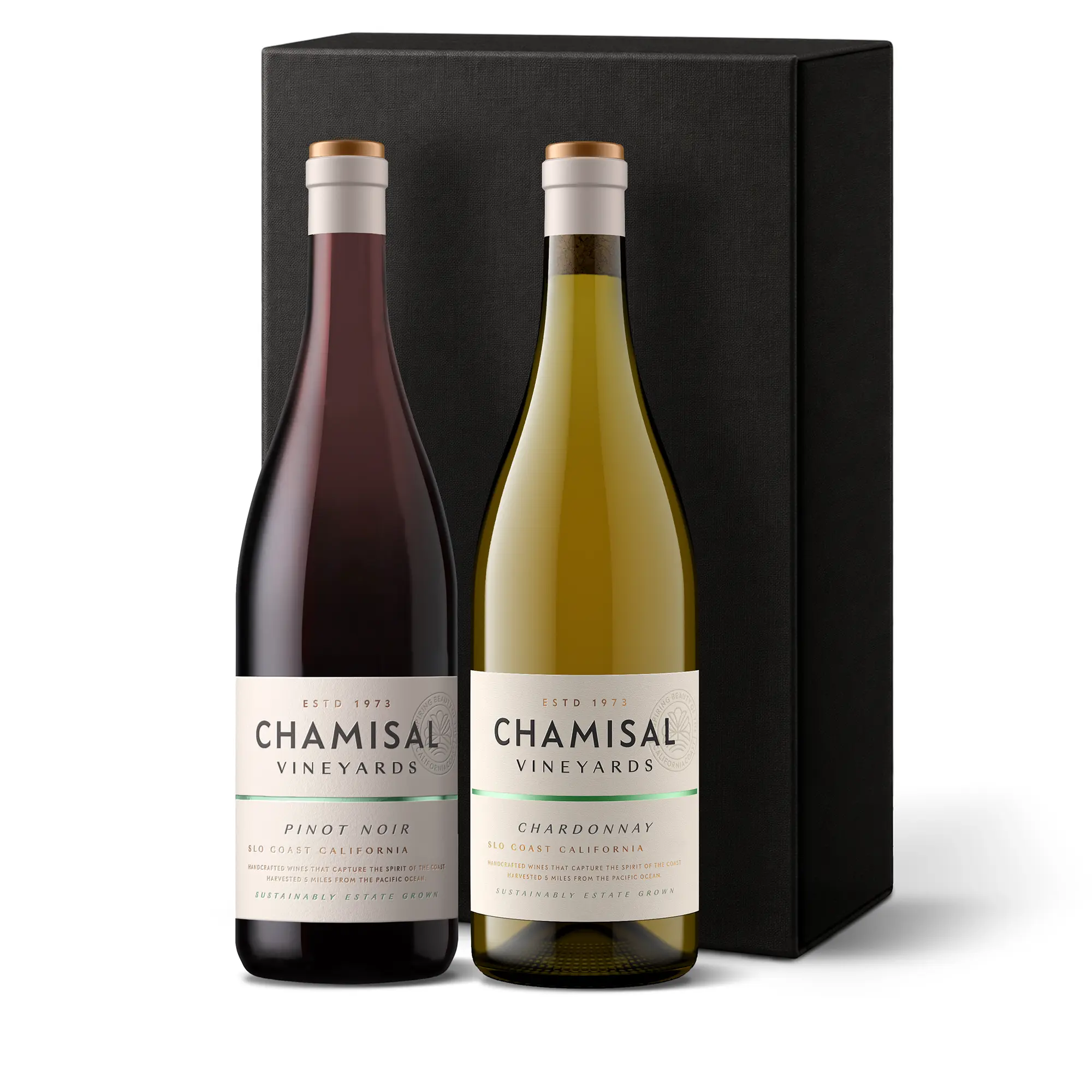 Two wine bottles, one red and one white, labeled Chamisal Vineyards, stand in front of a tall, black gift box. Showcasing the Califa Chardonnay & Pinot Noir 2-Bottle Gift, the red wine is Pinot Noir and the white wine is Chardonnay.