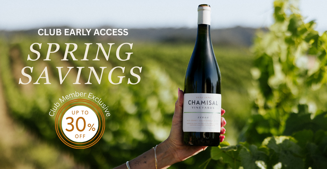 A hand holds a bottle of Chamisal Vineyards wine in a sunlit vineyard. Text reads: “Club Early Access Spring Savings” and “Club Member Exclusive Up to 30% Off.”.